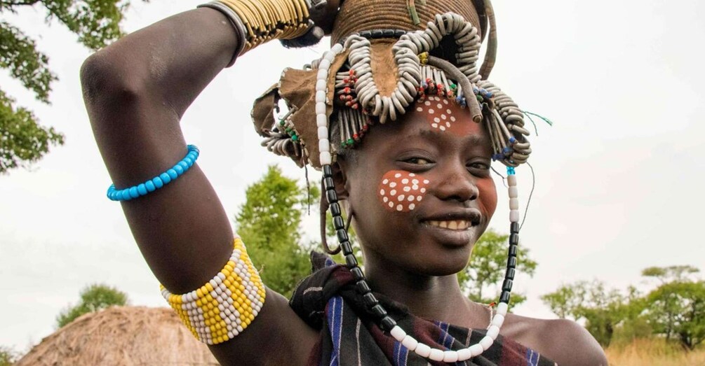 A person wearing traditional beaded jewelry and a headdress. 4