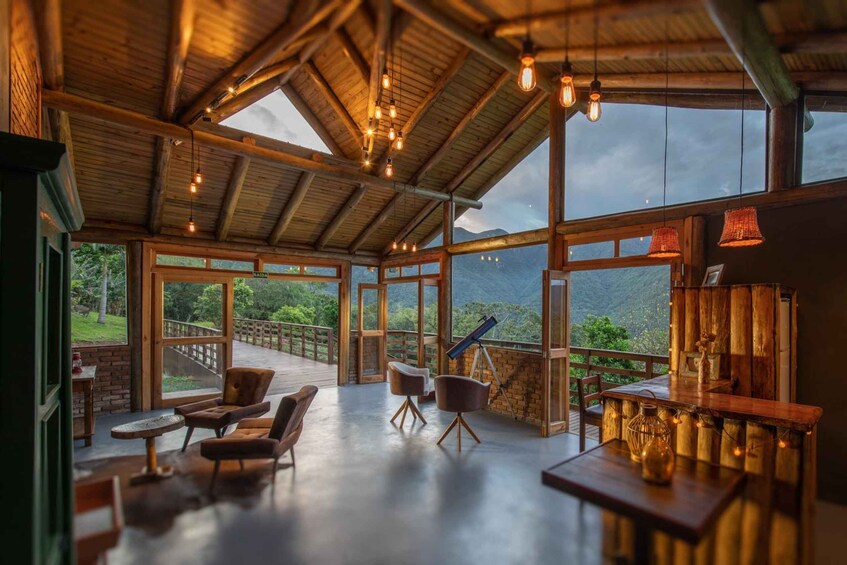 A wooden interior with large windows overlooking a mountainous landscape. 1