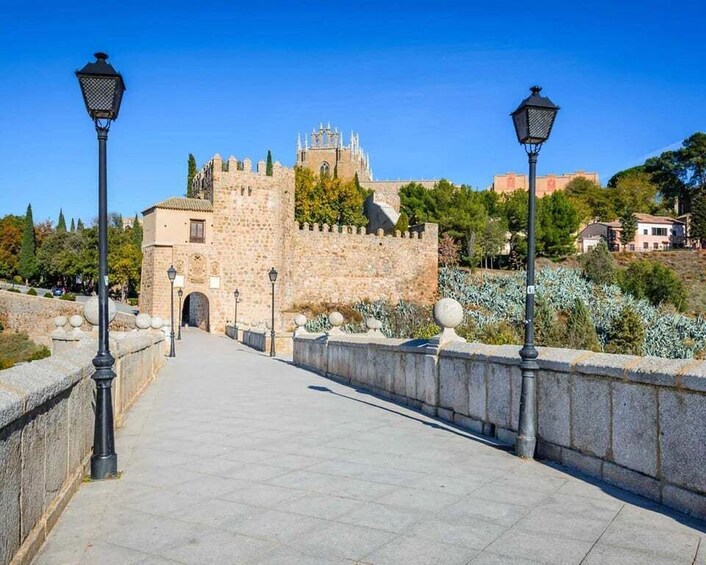 A stone bridge with a castle in the background. 1