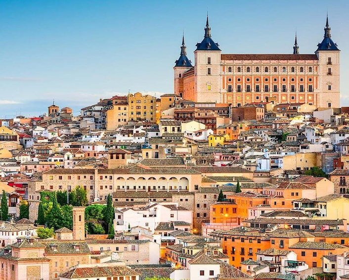 A densely packed urban landscape with historic architecture, including a prominent building with two towers. 2
