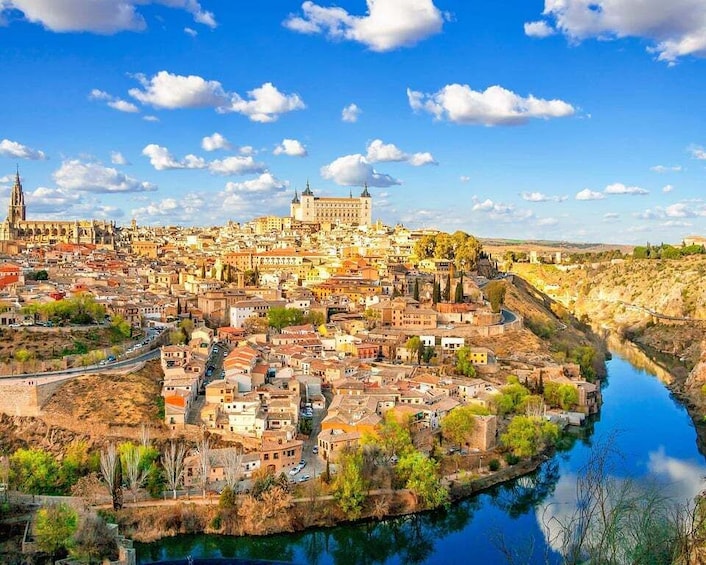 A cityscape with a prominent cathedral, a river, and surrounding hills. 5