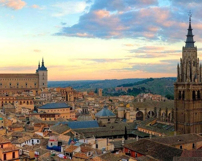 A cityscape with historic architecture, including a prominent tower and a cathedral. 4