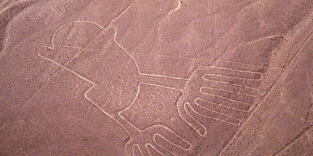 A rock with ancient handprints and a circular design. 1
