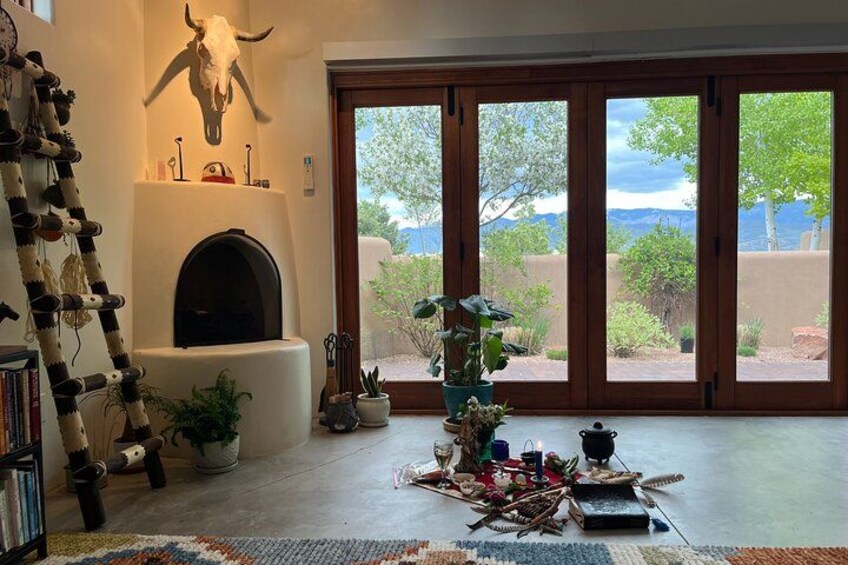 A living room with a fireplace, large windows, and a view of the outdoors. 2