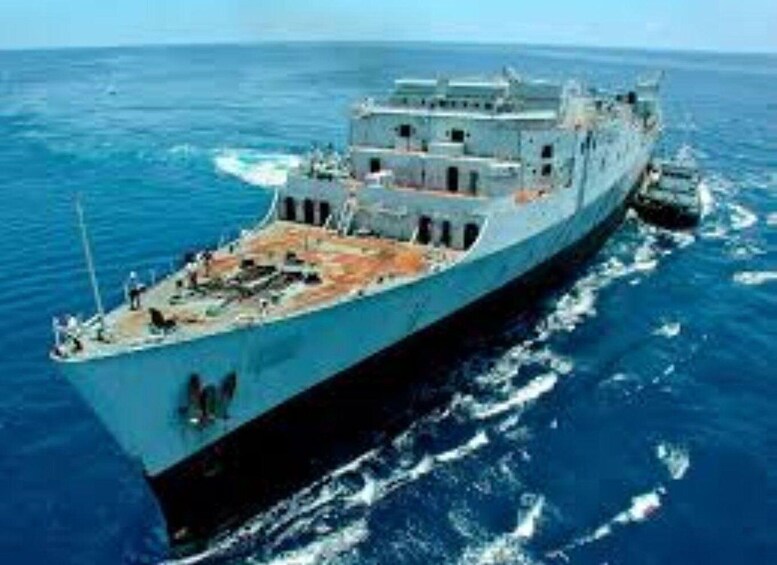 A large naval ship sailing on the ocean. 4