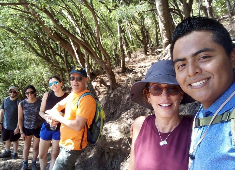 A group of people hiking on a forested trail. 5