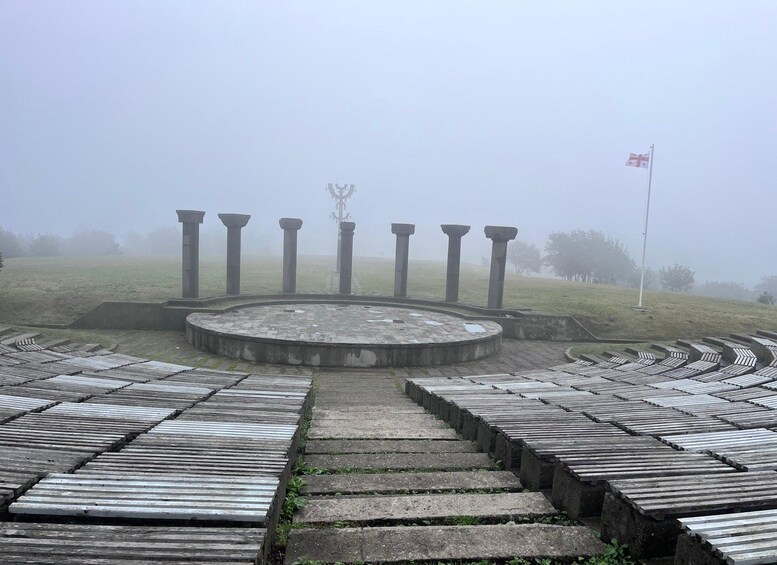 A foggy ancient amphitheater with stone steps and columns. 2
