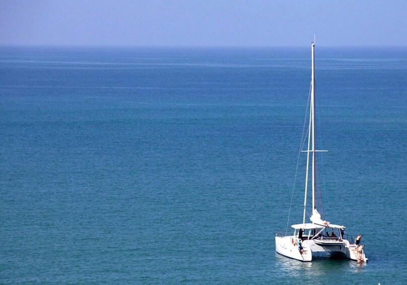 A sailboat on calm blue waters. 1
