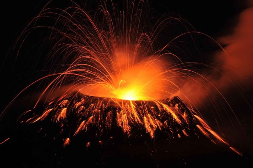 A volcano erupting with lava and ash. 2
