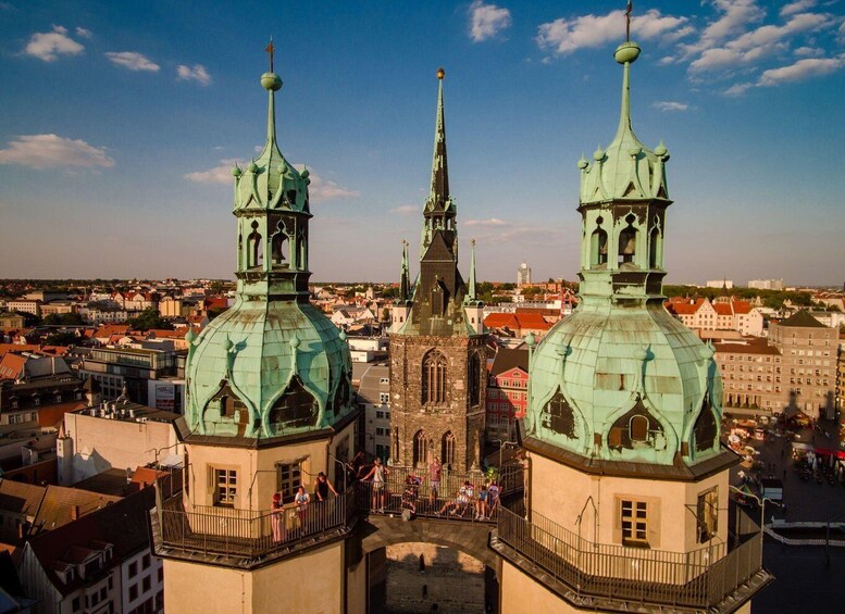 A historic church with two prominent green domes and a tall spire. 2