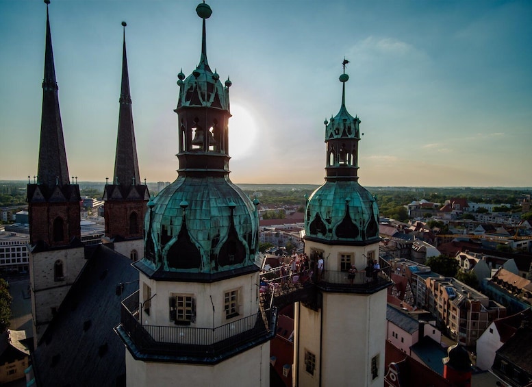 A cityscape with prominent church spires and a large dome. 3