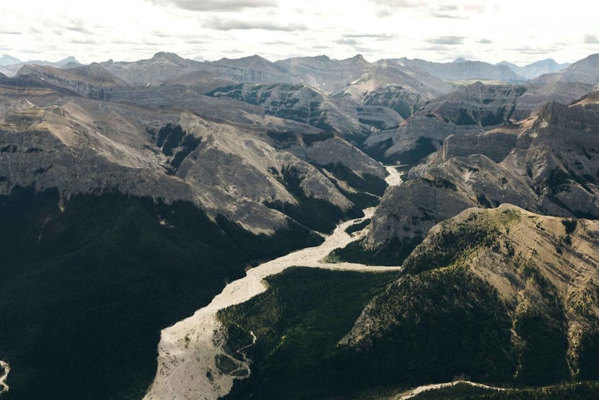A river winding through a mountainous landscape with rugged terrain and sparse vegetation. 4