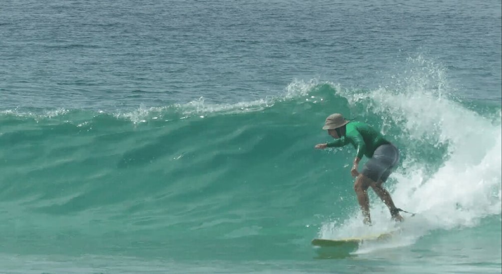 A surfer riding a wave in the ocean. 4