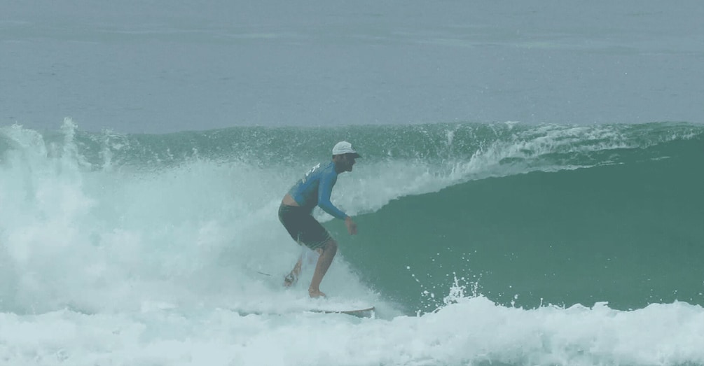 A surfer riding a wave in the ocean. 2