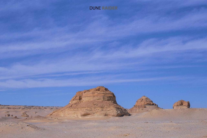 A desert landscape with prominent rock formations. 2