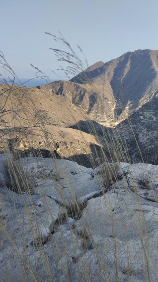 A mountainous landscape with rocky terrain and sparse vegetation. 3