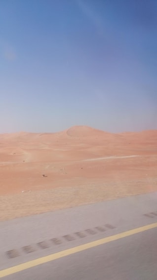 A desert landscape with sand dunes and a clear sky. 1