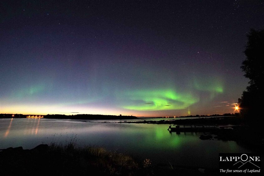 The Northern Lights over a calm lake at night. 4