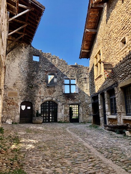 An old stone building with a cobblestone courtyard. 5
