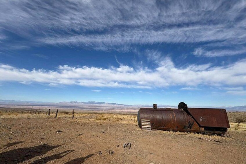 A rusty barrel in a barren landscape with a clear sky. 3