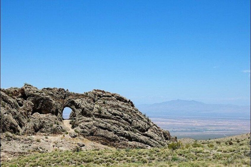 A rocky landscape with a natural arch formation. 2