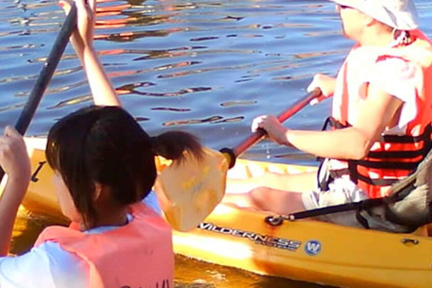 Two people kayaking on a yellow raft. 5