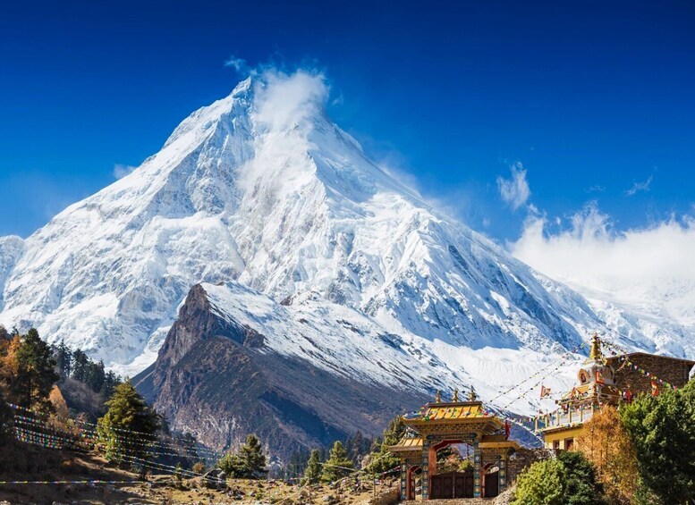 A snow-covered mountain with a temple in the foreground. 4