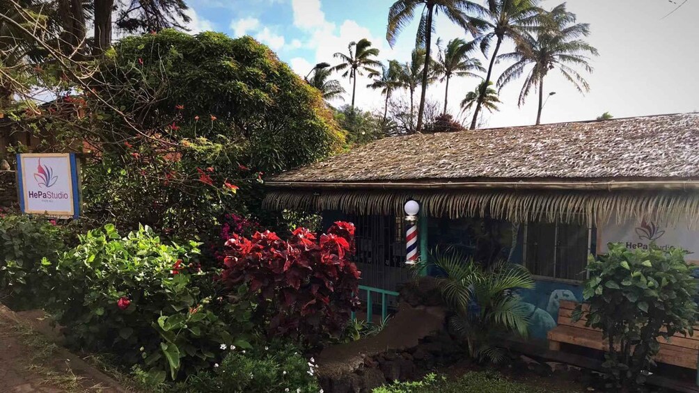 A thatched-roof building with a sign reading "HePaStudio." 1