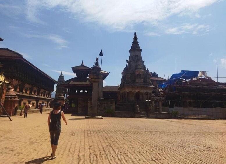 A historical temple complex with intricate architecture and a paved courtyard. 2