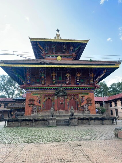 A traditional multi-tiered temple with intricate carvings and statues. 3