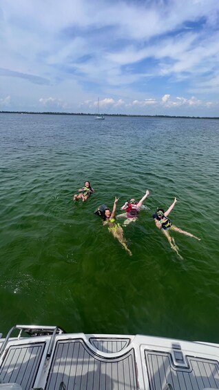 Four people swimming in a body of water. 5