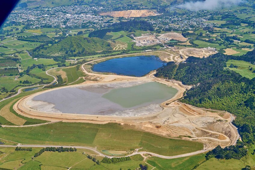 An aerial view of a mining area with multiple ponds and roads. 5