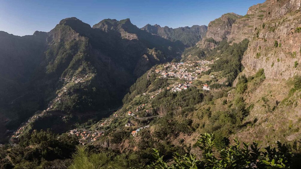 A mountainous landscape with a village nestled in a valley. 3