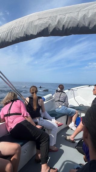 People on a boat with a clear sky and calm sea. 2