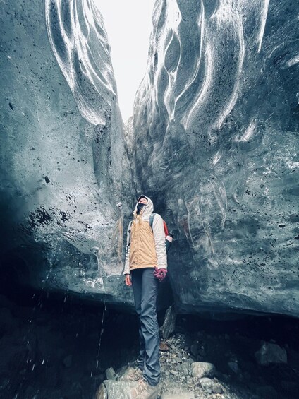 A person standing in a crevasse with ice walls. 2