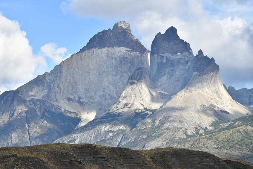 A mountain with a prominent peak and a waterfall. 2