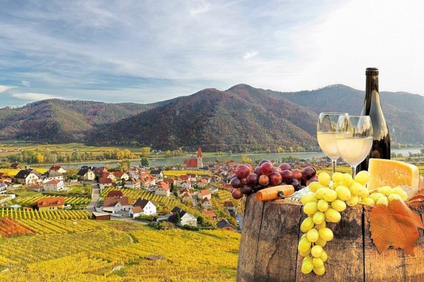 A vineyard with grapevines, a bottle of white wine, and a glass of wine on a wooden barrel. 1