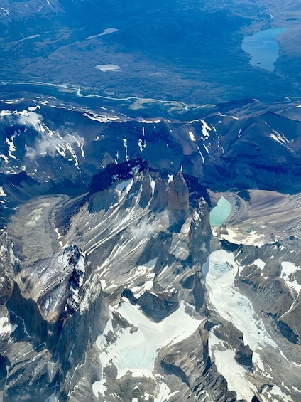 A rugged mountain range with snow-capped peaks and a glacier. 5
