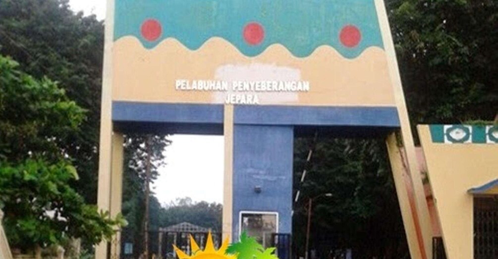 A sign with text, a blue structure, and greenery. 2