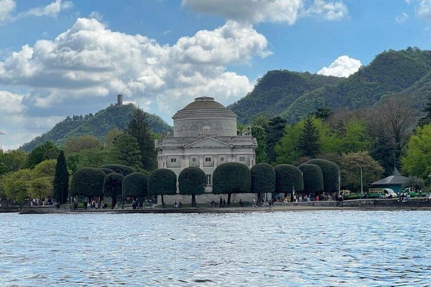 A large building with a dome, surrounded by trees and hills. 5