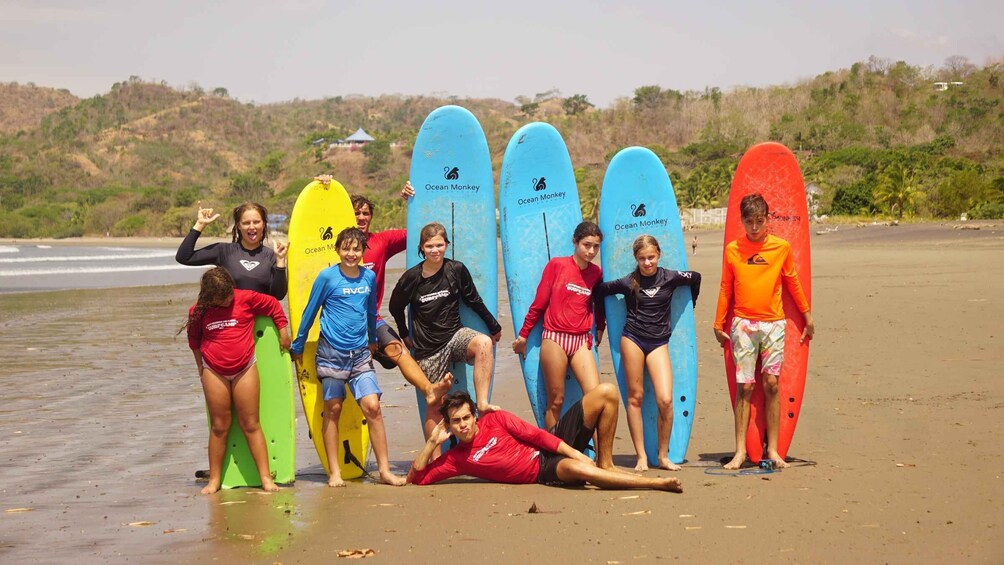 A group of people with surfboards on a beach. 2