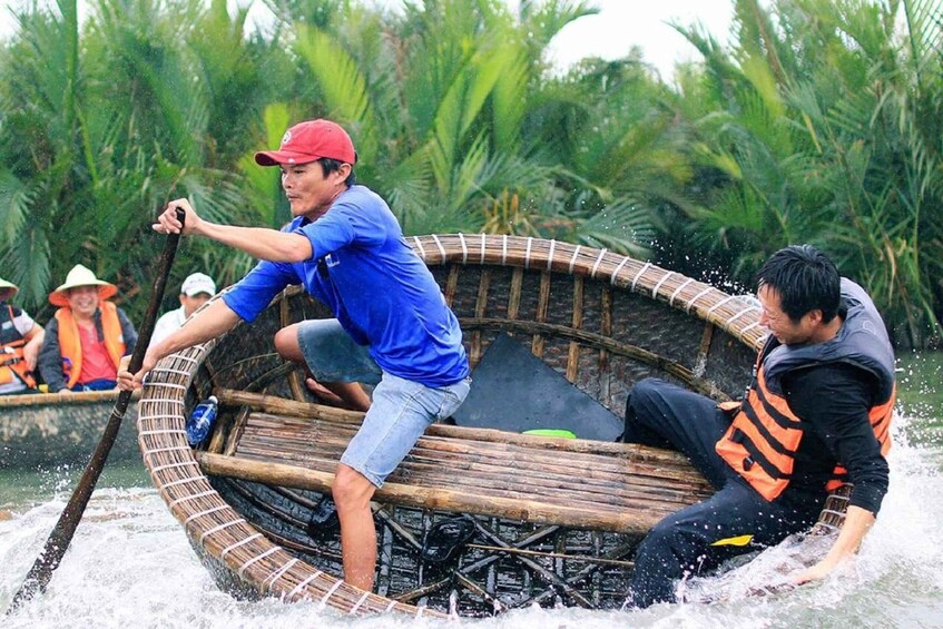 A group of people in a traditional bamboo boat navigating through water. 4