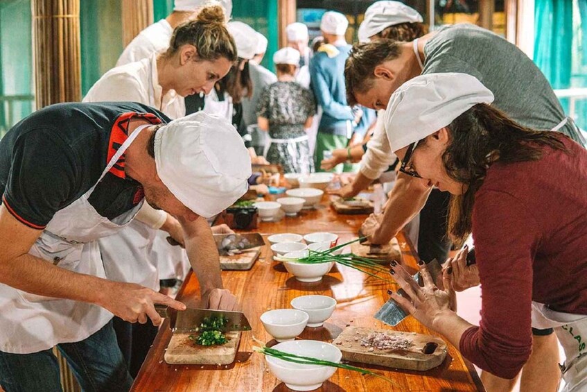 A group of people preparing food in a kitchen. 2