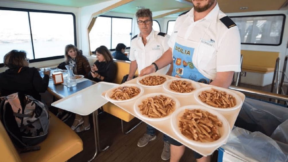 A person serving food on a boat. 2