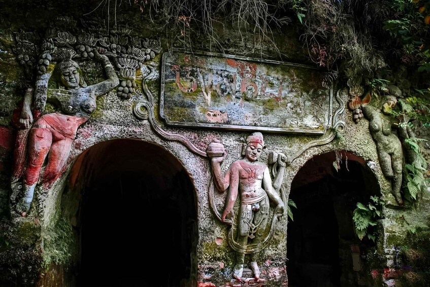 Ancient stone carvings and a weathered sign with inscriptions. 2