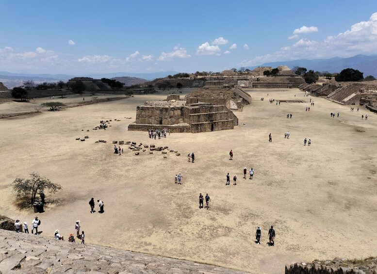An archaeological site with ancient ruins and visitors. 3