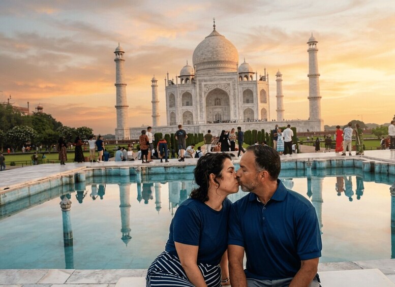 A couple kissing in front of the Taj Mahal with a reflection in the pool. 4