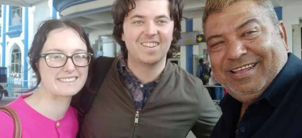 Three people standing in an airport terminal. 3