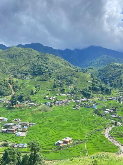 Terraced rice fields, houses, and mountains. 1