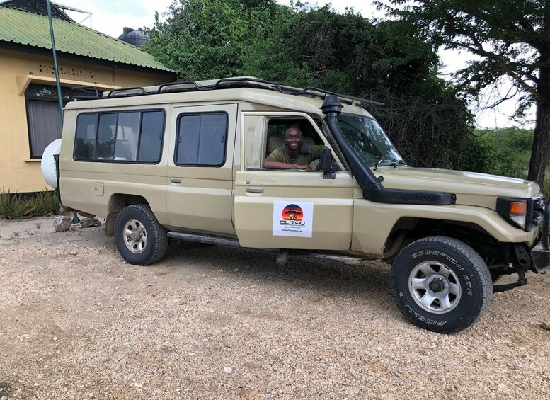 A beige Land Cruiser with a sticker on the side. 5